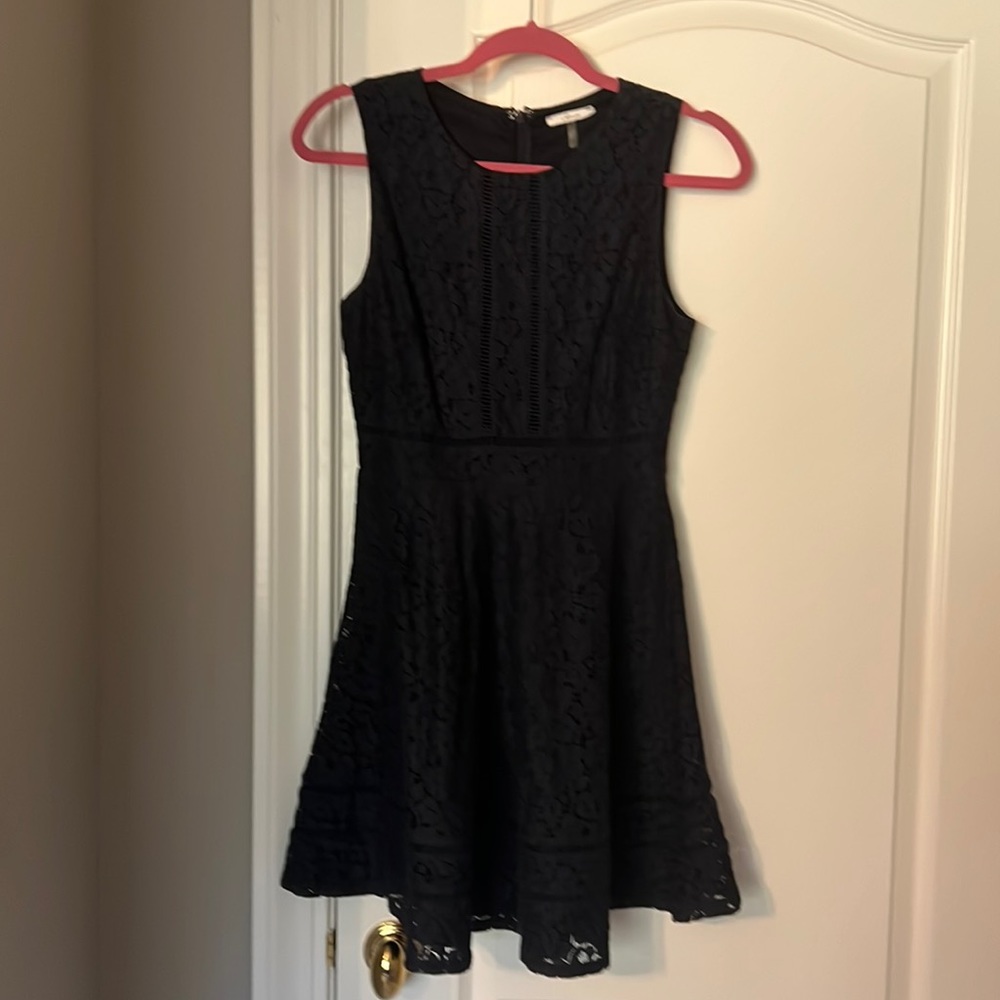 Navy blue lace A line dress with a slight peplum bottom.